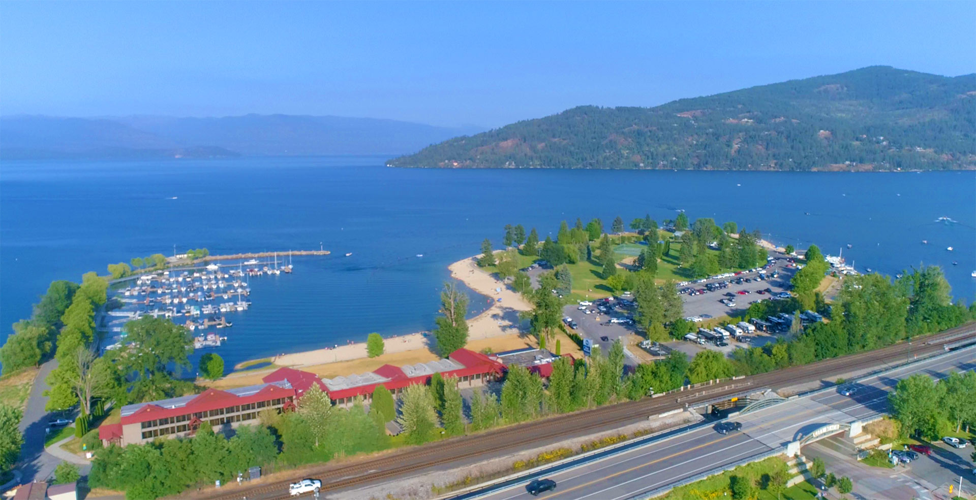 Aerial view of City Beach, a lakeside hotel, and the marina in Sandpoint